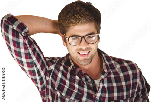 Hipster smiling while lying by laptop on hardwood floor