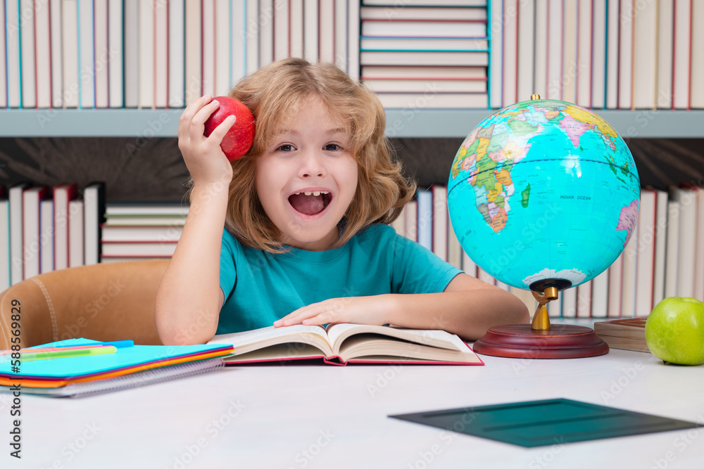 School boy with books and apple in library. Little student school child. Portrait of nerd student with school supplies. School boy with books and apple in library. Little student school child. Portrait of nerd student with school supplies.