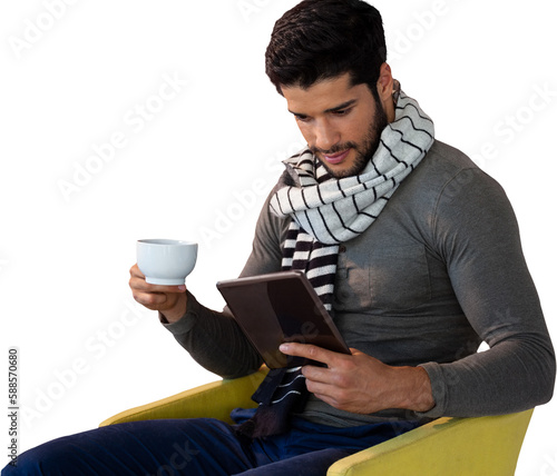 Man using digital tablet while having tea on seat