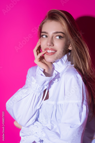 Sensual portrait of elegant young fashionable sexy happy smiling woman. Beautiful girl, fashion model. Fashion lady. Stylish woman in fashion trend shirt on pink. Sexy clothes.