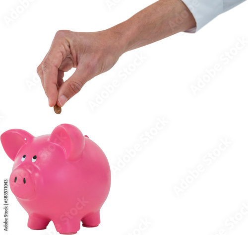 Cropped hand inserting coin in piggy bank