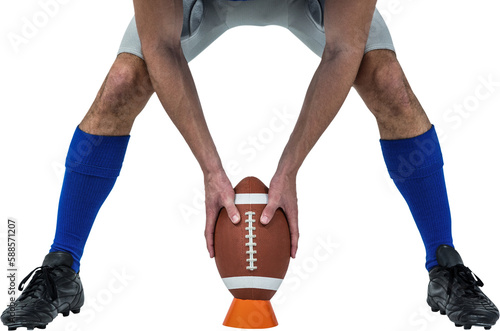 American football player placing ball between legs