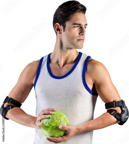 Confident athlete man holding a ball 