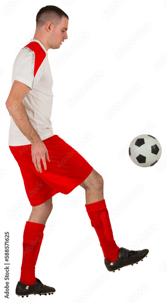 Fit football player playing with ball
