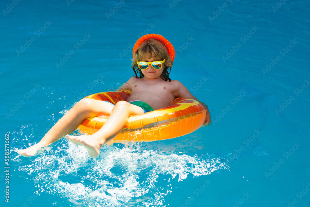 Child splashing in swimming pool. Active healthy lifestyle, swim water sport activity on summer vacation with child. Child water toys.