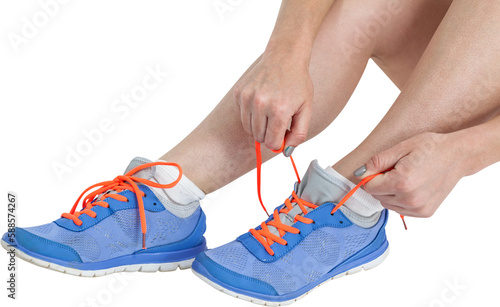 Athlete woman tying her running shoes
