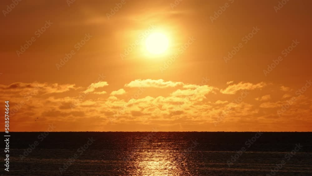 Dramatic sea sunset. Burning sky and shining waves. Warm clouds and pure ocean water at sunrise. Nature cinematic seascape shot in 8k resolution 4320p. Dramatic sea sunset. Burning sky and shining waves. Warm clouds and pure ocean water at sunrise. Nature cinematic seascape shot in 8k resolution 4320p.