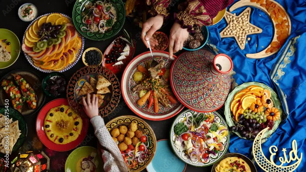 Eid al-Fitr is the festival that marks the end of the holy month of Ramadan. Muslim family celebrates together. Moroccan cuisine, festive food. Symbols of Islam. Eid al-Fitr is the festival that marks the end of the holy month of Ramadan. Muslim family celebrates together. Moroccan cuisine, festive food. Symbols of Islam.