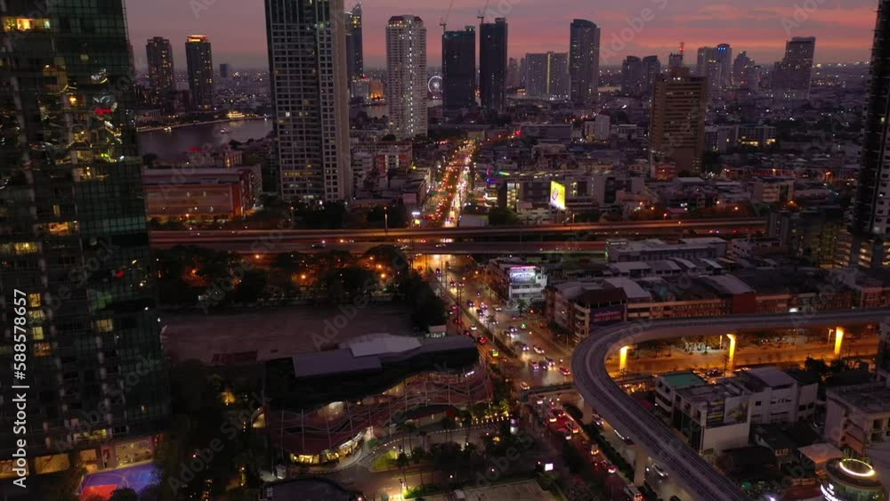 sunset sky bangkok city illuminated downtown traffic street road interchange aerial panorama 4k thailand  