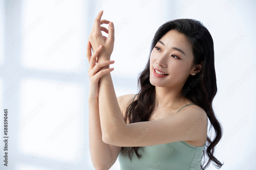 Young beautiful Chinese woman putting on make up Young beautiful Chinese woman putting on make up