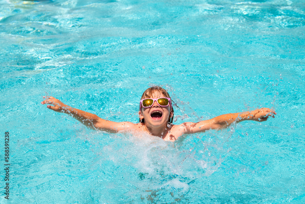 Kid in swimming pool, relax swim on inflatable ring and has fun in water on summer vacation.