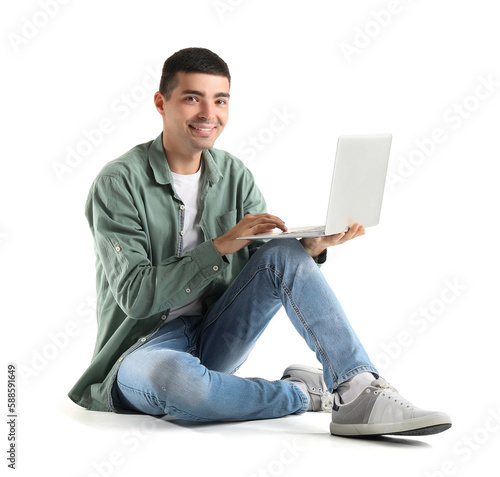 Young guy using laptop on w...