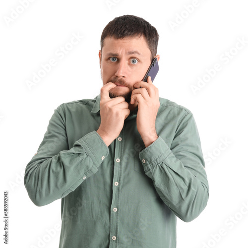 Handsome man biting nails a...