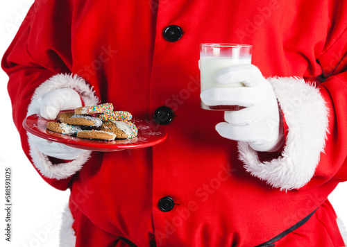 Midsection of Santa claus holding glass of milk and cookies