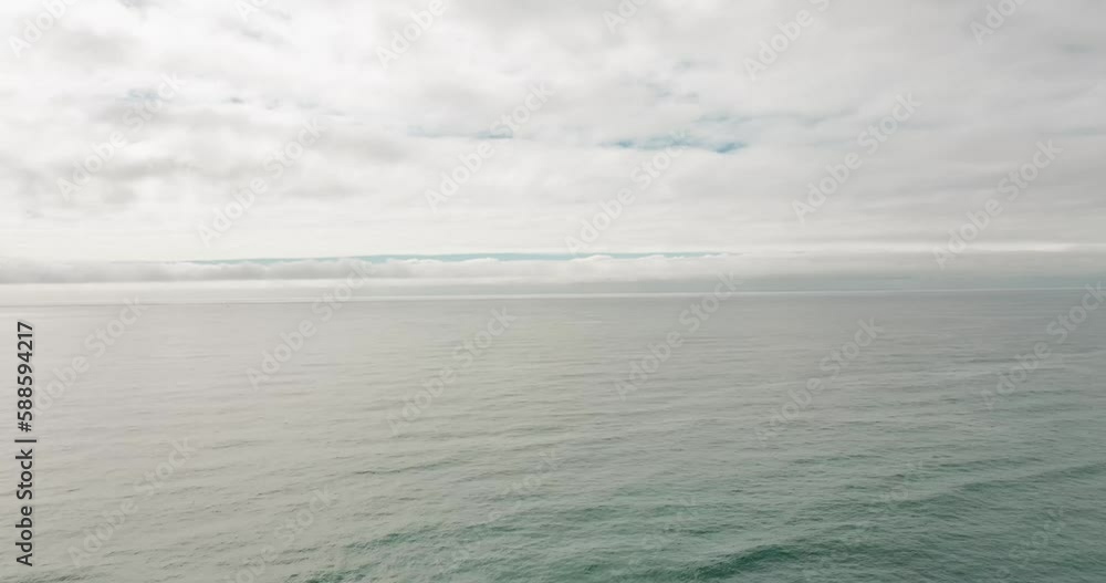 aerial time lapse of thick white clouds passing over the pacific oceans with calm waves and streaks of blue skies showing aerial time lapse of thick white clouds passing over the pacific oceans with calm waves and streaks of blue skies showing