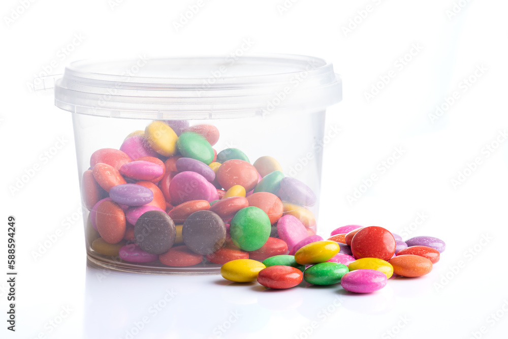 Multicolored candies in a jar isolated on a white background Multicolored candies in a jar isolated on a white background