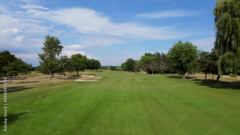 Drone flying close over golf course fairway on a sunny day in Toronto. Drone flying close over golf course fairway on a sunny day in Toronto.