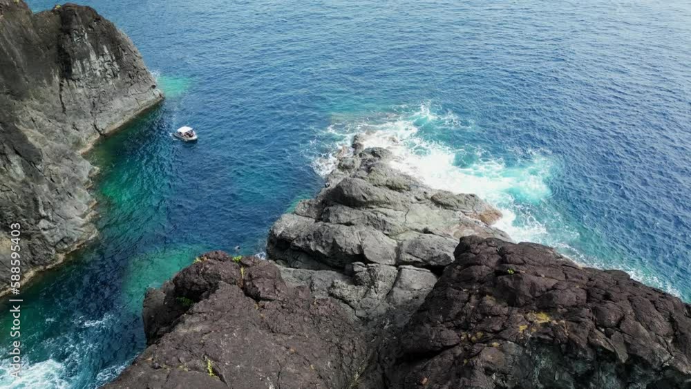 Small Yacht Sailing Near The Seashore To Explore The Beach In Catanduanes, Philippines. aerial drone Small Yacht Sailing Near The Seashore To Explore The Beach In Catanduanes, Philippines. aerial drone