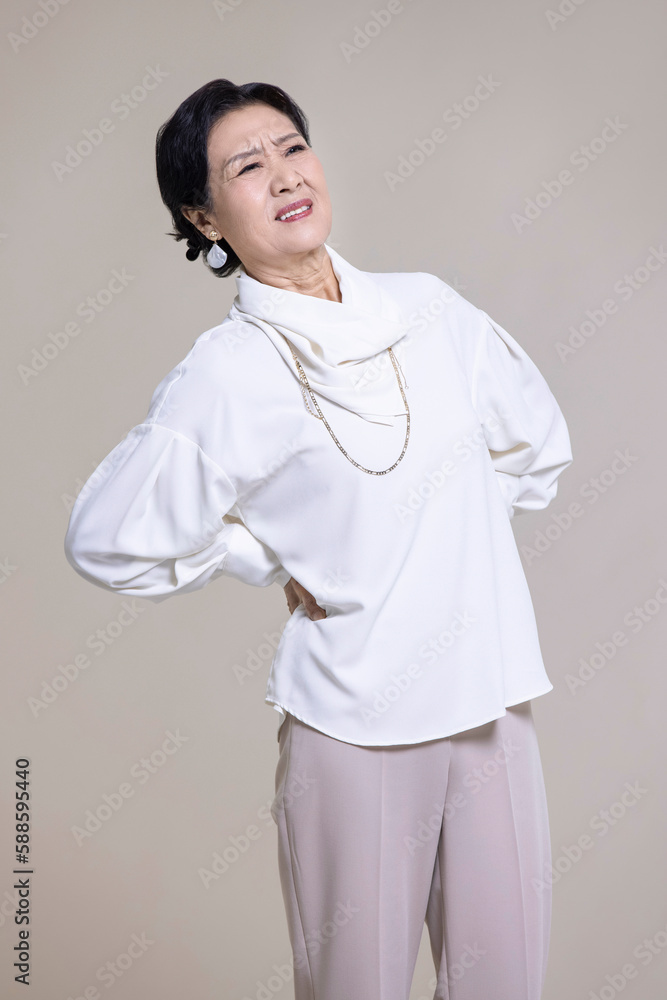 Senior Chinese woman suffering from backache Senior Chinese woman suffering from backache