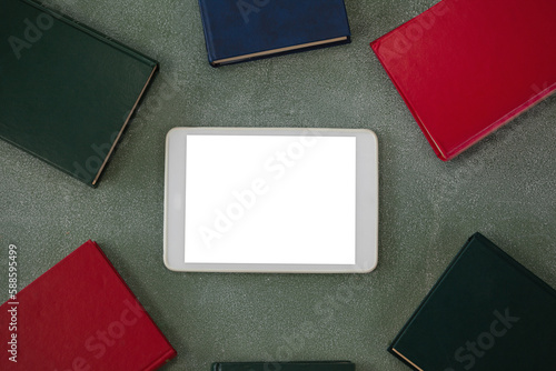 Oberhead view of digital tablet surrounded with colorful organizers