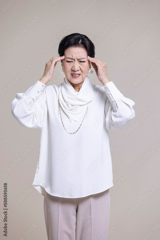 Senior Chinese woman feeling unwell Senior Chinese woman feeling unwell