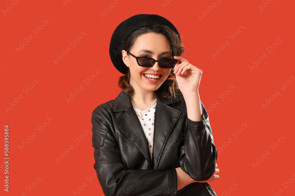 Stylish young woman in sunglasses on red background Stylish young woman in sunglasses on red background