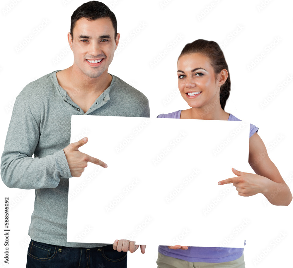 Smiling young couple pointing at sign they are holding Smiling young couple pointing at sign they are holding