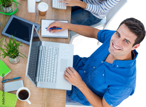 Creative businessman smiling at the camera 