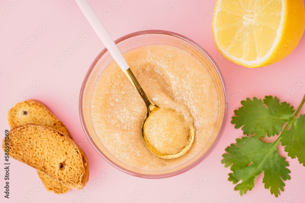 Glass with delicious caviar of capelin and croutons on pink background Glass with delicious caviar of capelin and croutons on pink background