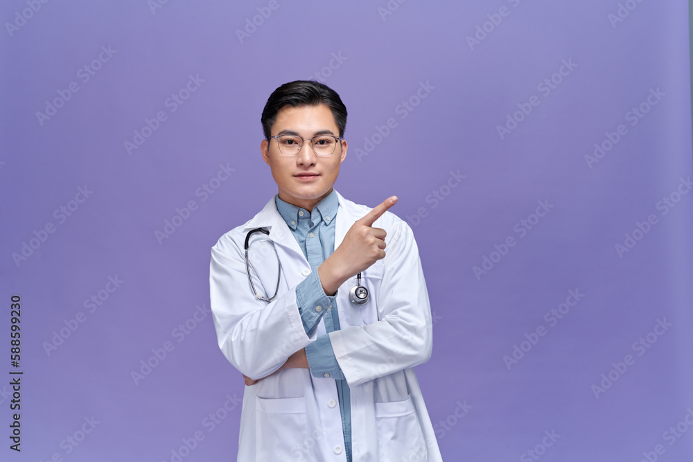 Medical concept of professional male doctor pointing with hand on copy space Medical concept of professional male doctor pointing with hand on copy space