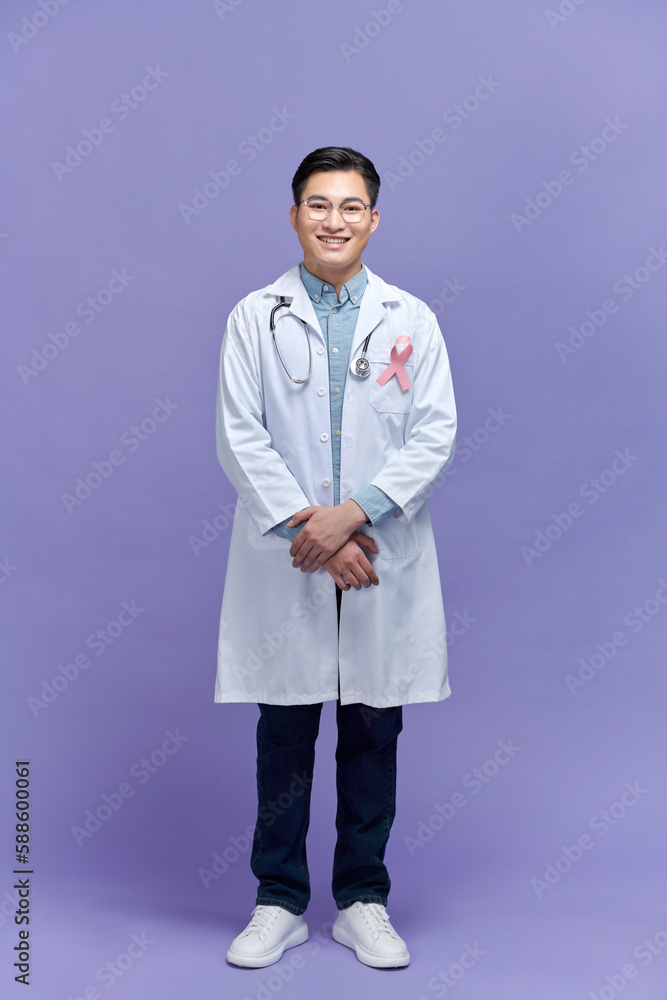 casian doctor man with a pink ribbon for the breast cancer awareness pinned in the flap of his white coat casian doctor man with a pink ribbon for the breast cancer awareness pinned in the flap of his white coat
