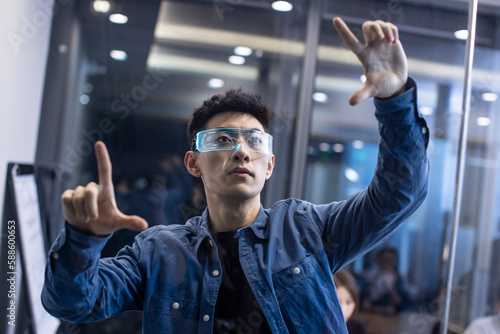 Young Chinese man wearing futuristic glasses