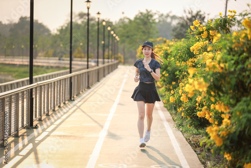 young woman relax in garden road evening ,woman fitness silhouette sunrise jogging workout wellness concept.