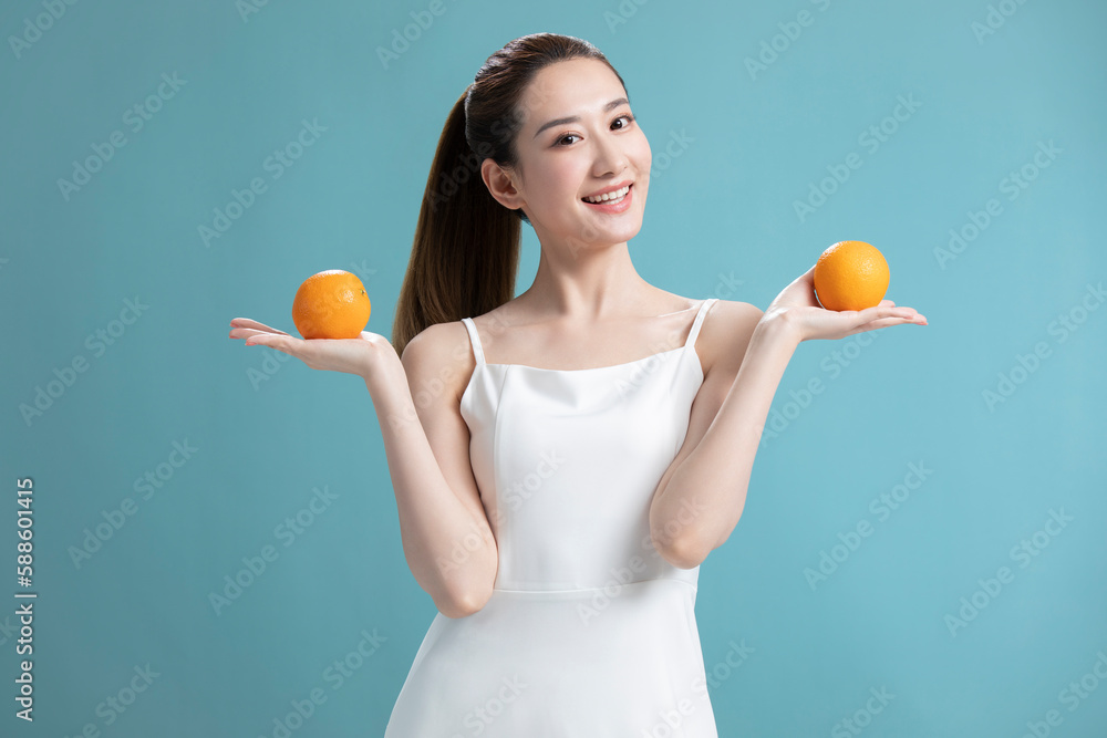Beautiful young Chinese woman with oranges Beautiful young Chinese woman with oranges