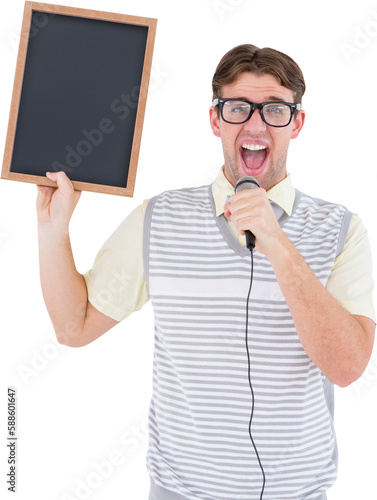 Geeky hipster holding blackboard and singing into microphone