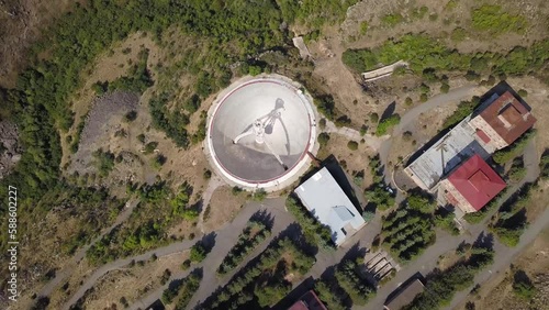 Downwards Rotating Aerial Shot of Mount Aragats Radio Optical Telescope's Herouni Mirror on a Sunny Day, Armenia (UHD) photo