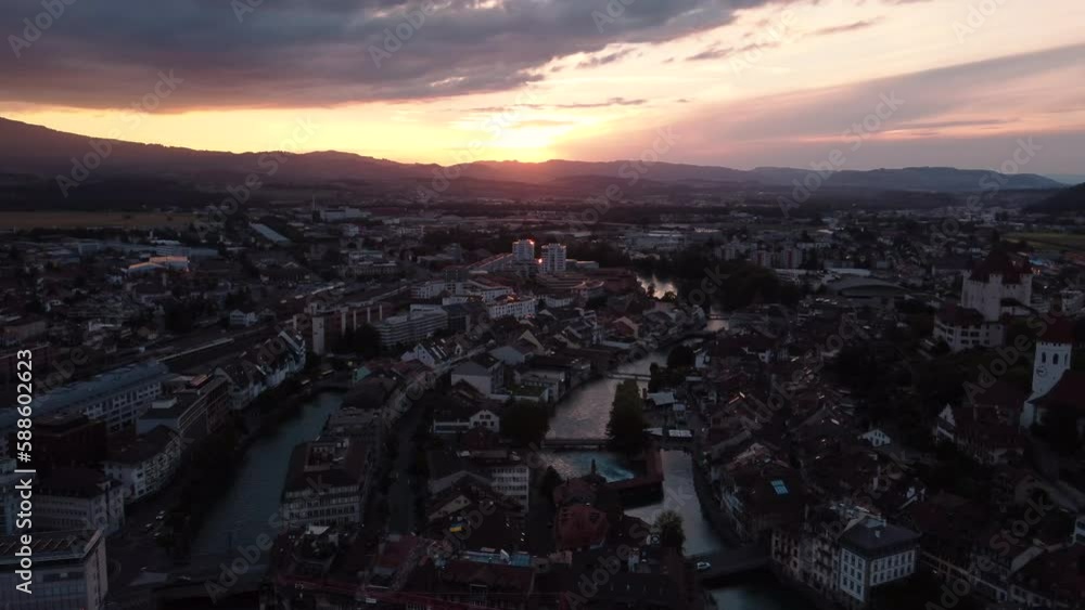 Overview over the alpine city Thun in Switzerland canton Bern. Beautiful old town with a castle on the banks on river Aare. View by sunset Overview over the alpine city Thun in Switzerland canton Bern. Beautiful old town with a castle on the banks on river Aare. View by sunset