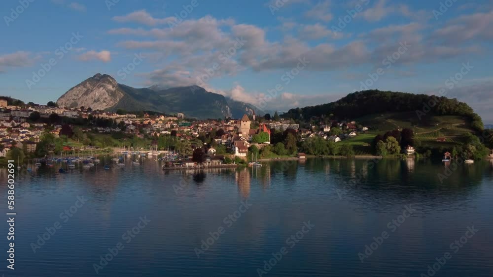 Slow flight over lake Thun getting closer to the castle and city of Spiez. Highlands of canton Bern, Switzerland Slow flight over lake Thun getting closer to the castle and city of Spiez. Highlands of canton Bern, Switzerland