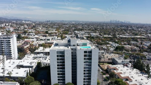 Wide panning aerial shot of a luxury condo tower in West Hollywood, California. 4K photo