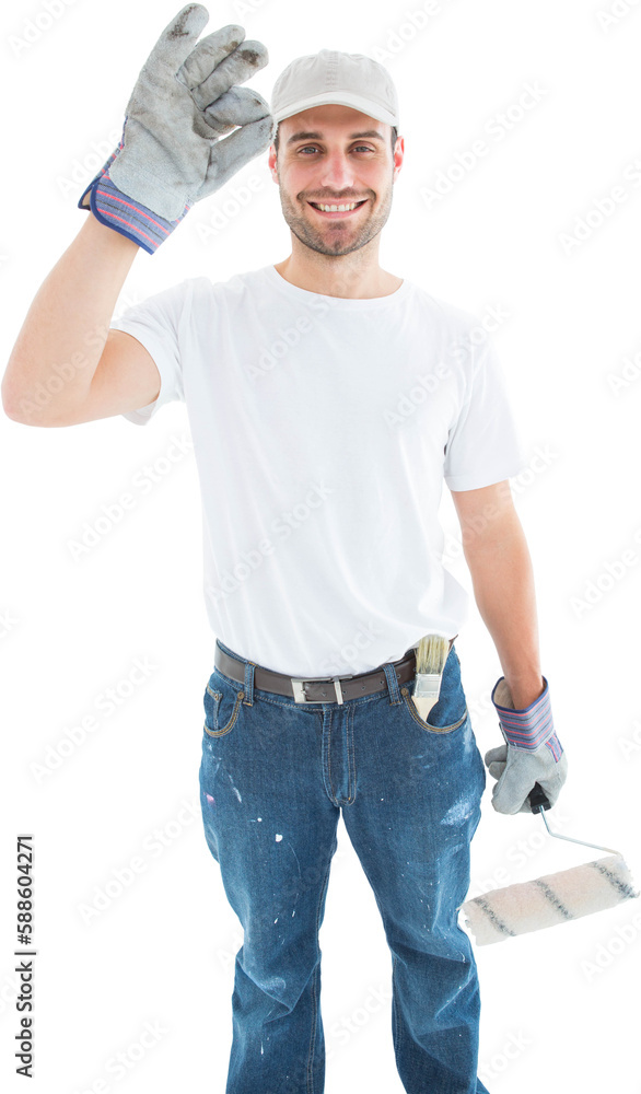 Happy man wearing gloves while holding paint roller Happy man wearing gloves while holding paint roller