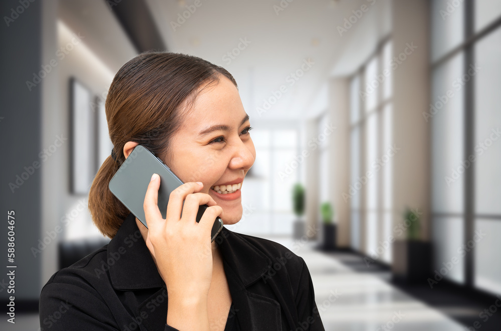 Asian businesswoman talking on mobile phone Asian businesswoman talking on mobile phone