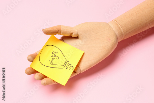 Wooden hand and sticky pape...