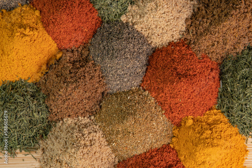 Heap different Asian Spices lies on wooden background. Spice and seasoning. Various fragrant spice market. Assortment spices and herbs for cooking