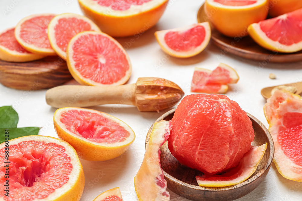 Ripe juicy grapefruits on light table, closeup Ripe juicy grapefruits on light table, closeup
