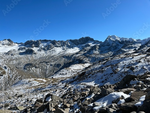 The melting of fresh autumn snow in the wonderful environment of the Swiss mountain massif Abula Alps, Zernez - Canton of Grisons, Switzerland (Kanton Graubünden, Schweiz) photo