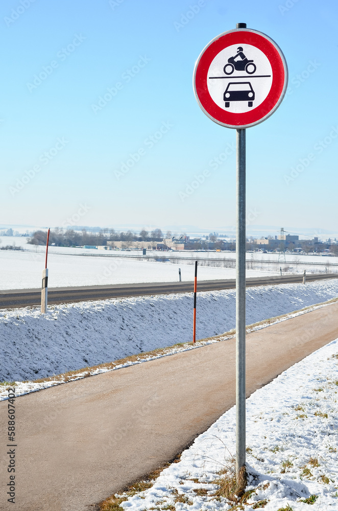 Motorcycles and cars prohibition sign in city on winter day