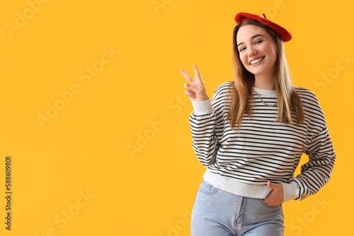 Young woman showing victory...