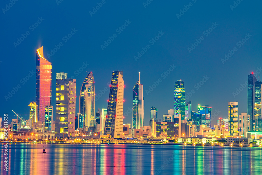 Kuwait Skyline view from beach during the national day celebration. Kuwait National day lights on the building and Kuwait flag lights during the night time. Kuwait City skyline view....