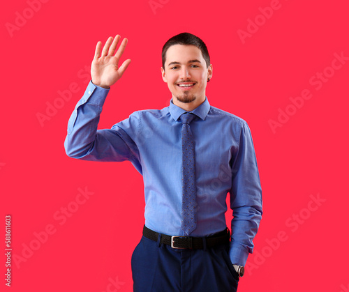 Handsome businessman waving...