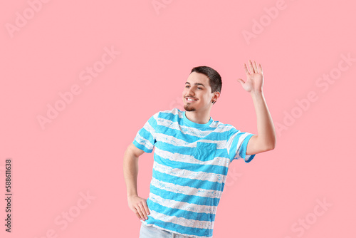 Handsome young man waving h...